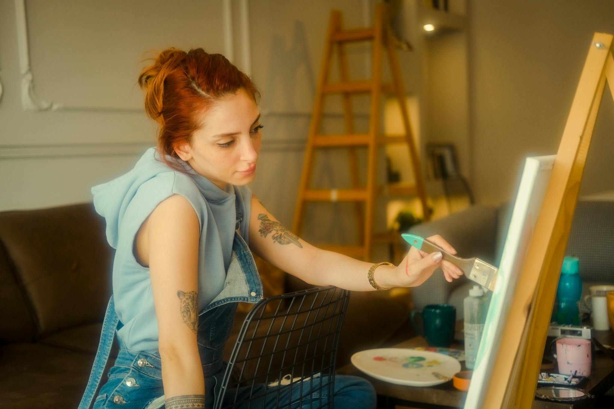 Creative woman painting in home studio, surrounded by artistic tools. Perfect for lifestyle and art themes.